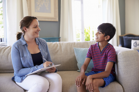 Psychologist performing psychological assessment on boy child
