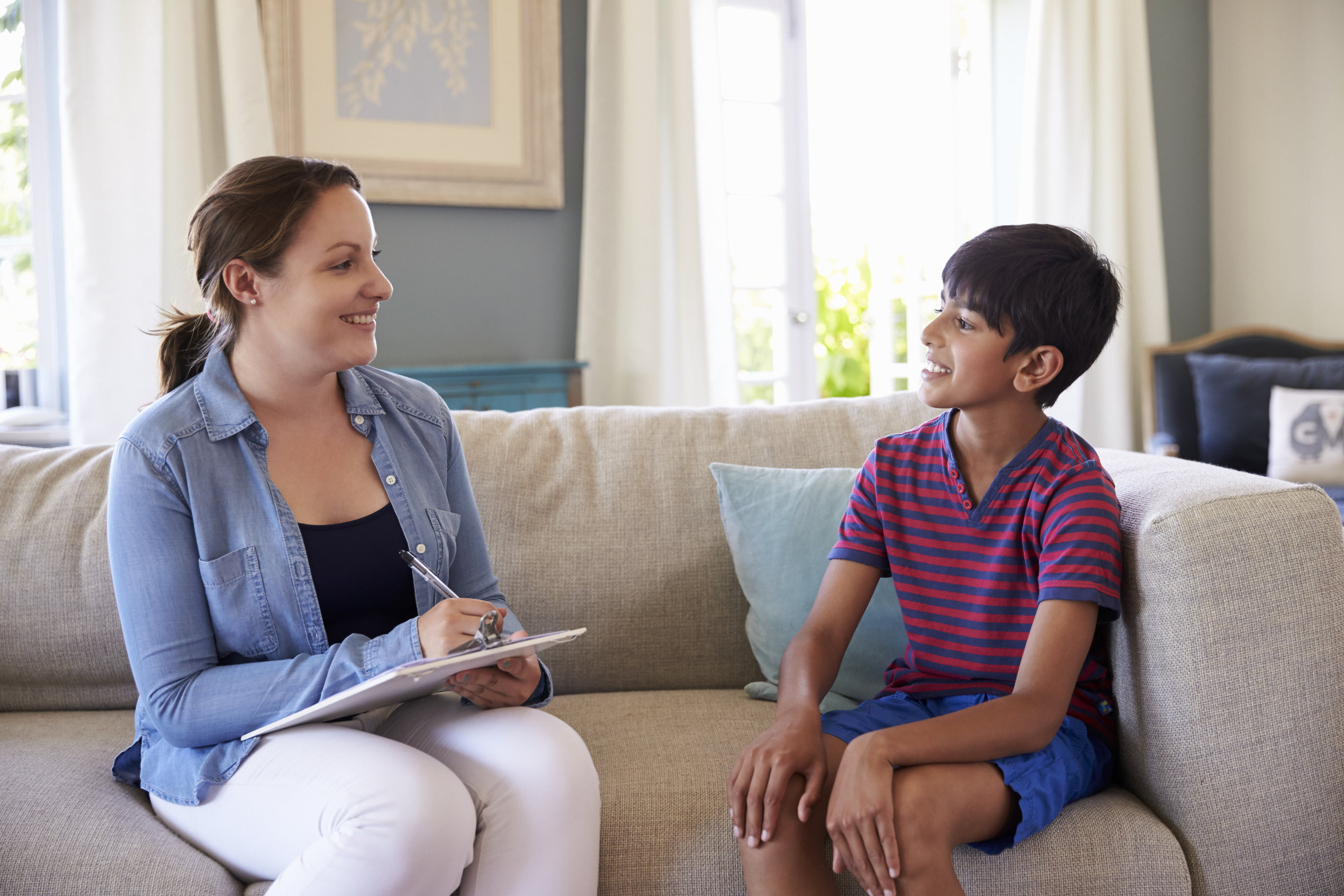 Psychologist performing psychological assessment on boy child